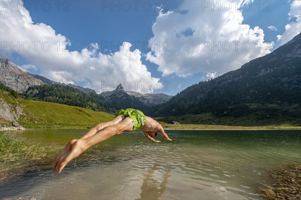 Young man jumps into Funtensee