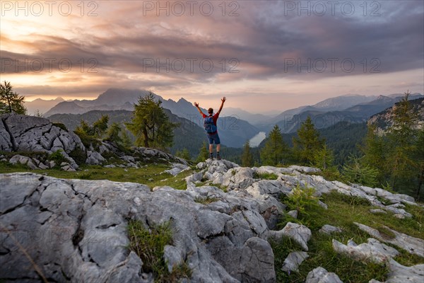 Hiker stretches his arms into the air