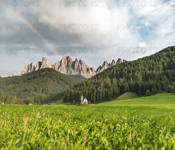 Rainbow in front of the church St. Johann in Ranui