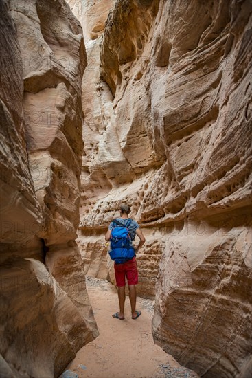 Young man standing in ravine of Slot Canyon