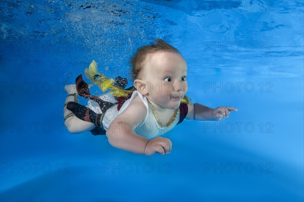 Little boy swims underwater