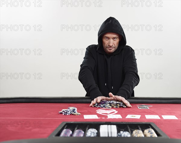 Man in hooded sweater going all-in