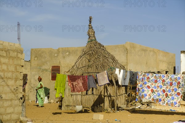 Straw hut next to stone houses