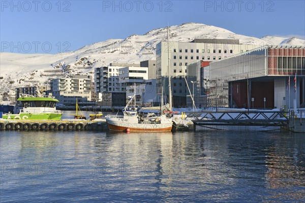 Boats and residential buildings on the shore of a bay