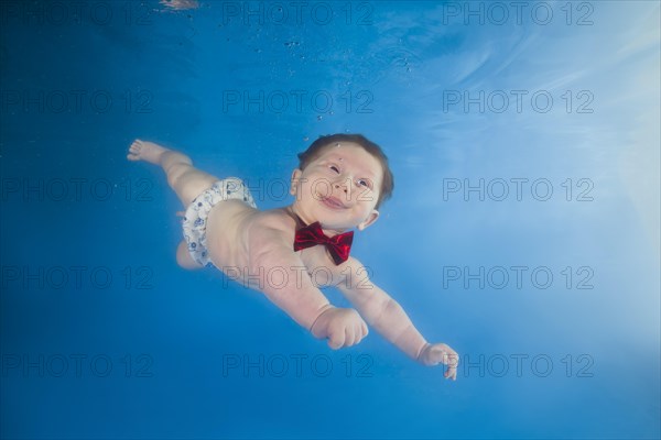 Baby boy diving in the pool