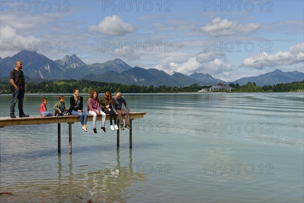 Family sitting on pier