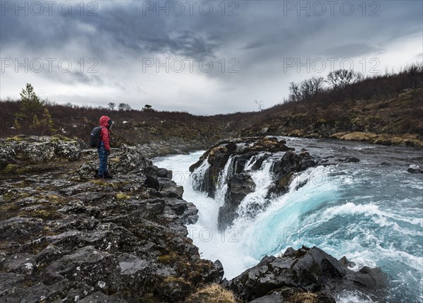 Hiker at Hlauptungufoss Waterfall