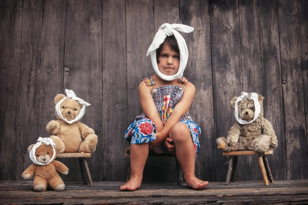 Four-year girl and teddy bears with toothache