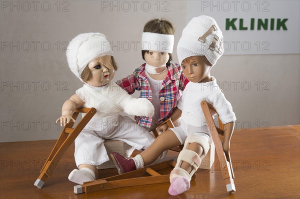 Three dolls sitting