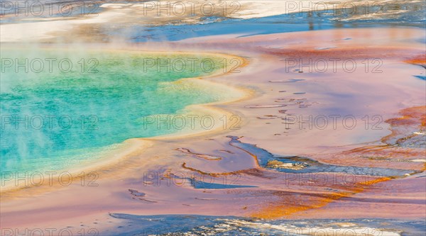 Colored mineral deposits at the edge sr steaming hot spring