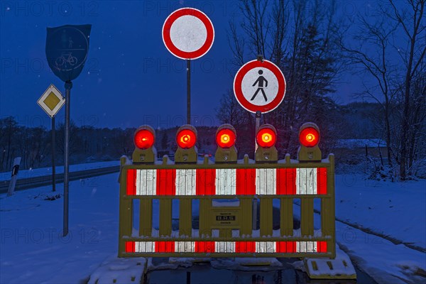 Illuminated snow barrier in winter at dusk