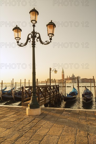 Lamppost with gondolas in San Marco and Benedictine church of San Giorgio Maggiore on San Giorgio Maggiore island