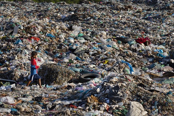 Little girl in garbage dump