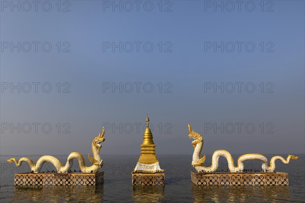 White Naga statues with golden Chedi on the shore of Lake Kwan Phayao