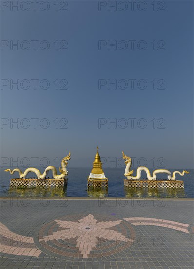 White Naga statues with golden Chedi on the shore of Lake Kwan Phayao