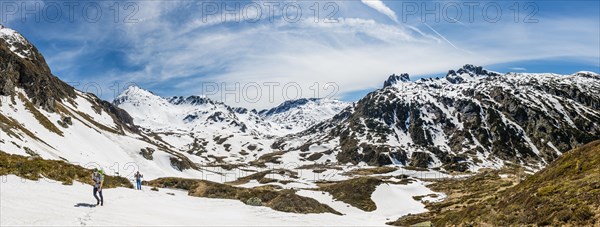 Two hikers walk over snowfield