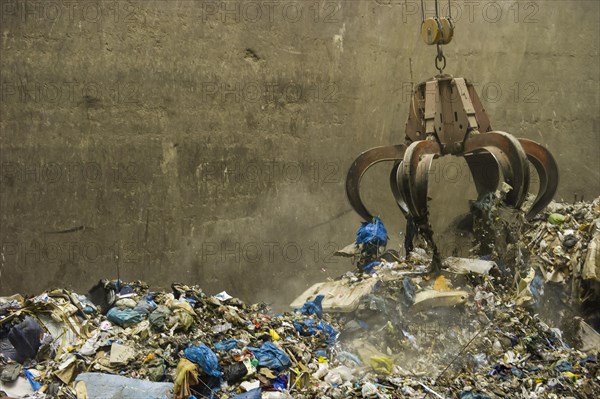 A crane transports waste in a waste-to-energy plant