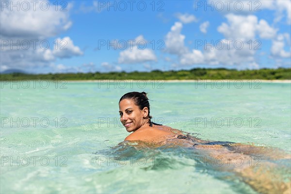 Young woman swimming in water