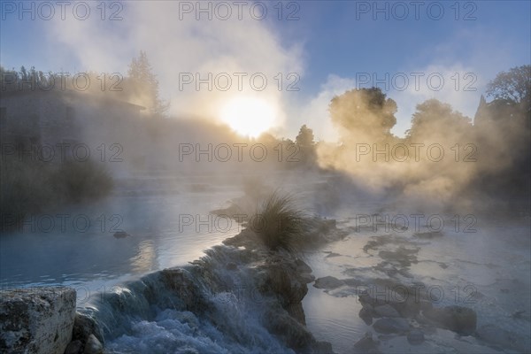 Steam is arising from the hot springs of Saturnia Therme in the morning