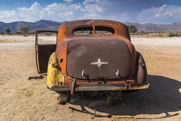 Old car wreck in sand