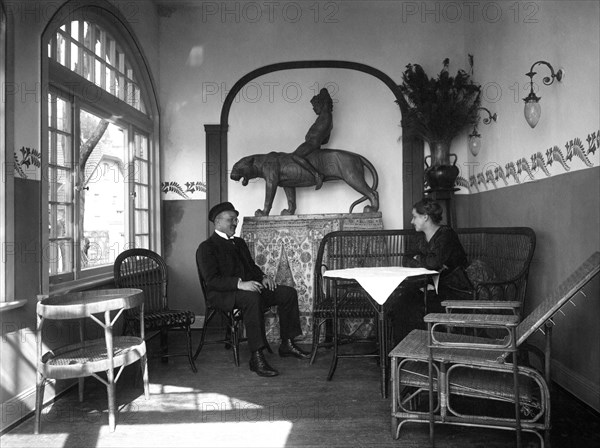 Couple sits in winter garden and converses