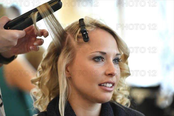 Young woman being styled at the hair salon
