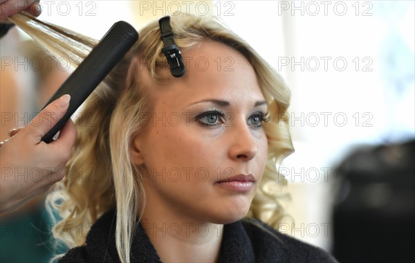 Young woman being styled at the hair salon