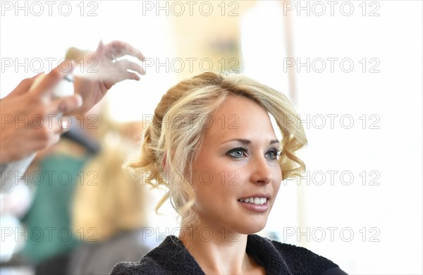 Young woman being styled at the hair salon