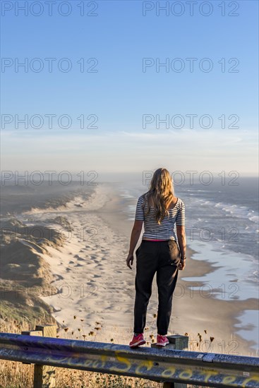 Young woman looking into the distance at a vantage point