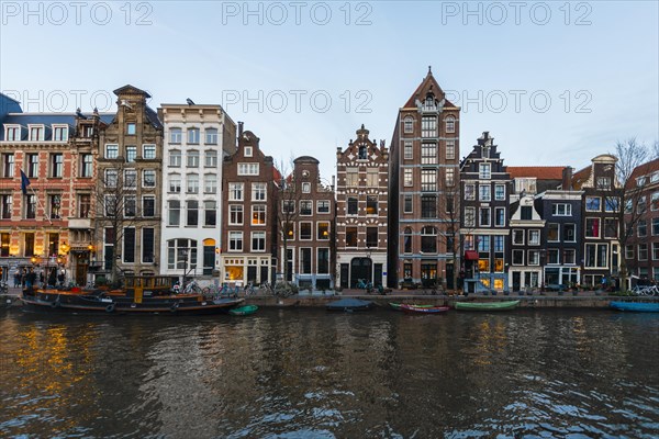 Historic row of houses on a canal at dusk