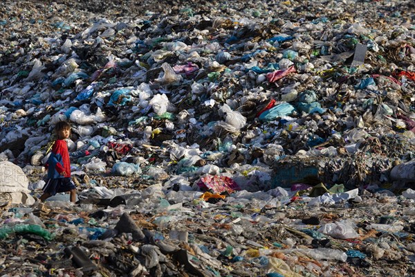 Little girl in garbage dump