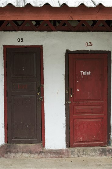 Toilet hut with red doors