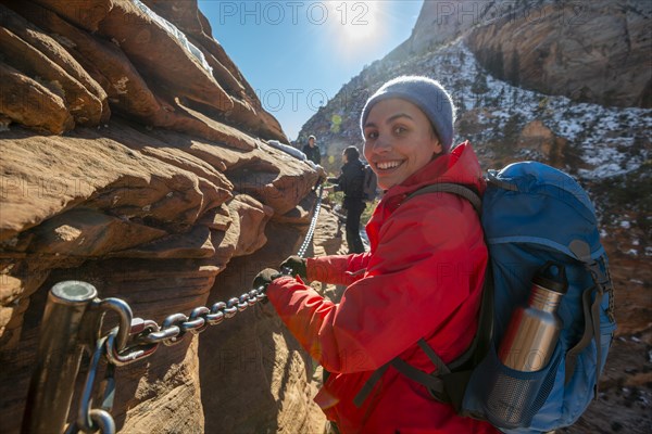 Young woman hiking on the via ferrata of the Angels Landing Trail