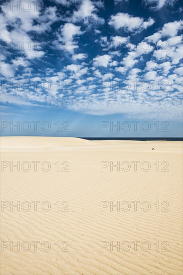 Dunes against blue sea