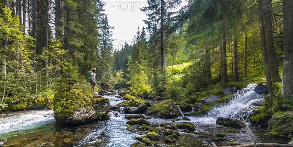 Hiker on a rock in the river