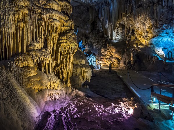 Stalactites in the colorfully lit cave Cuevas de Nerja