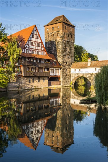 Old half-timbered house and water tower by the river Pegnitz