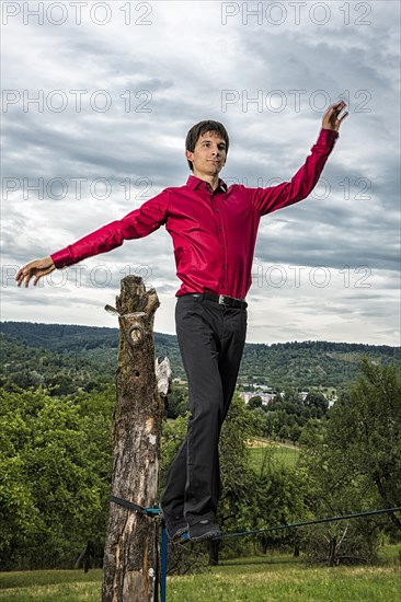 Young man balancing on slackline