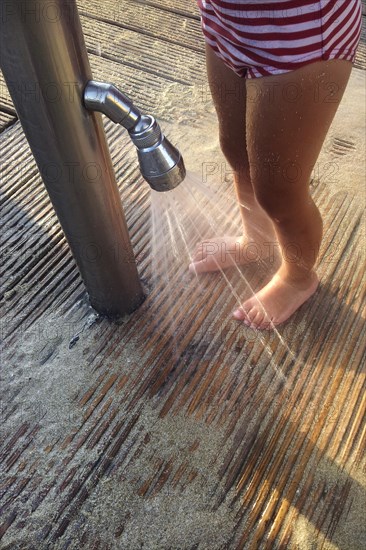 Girl washing sand off her feet