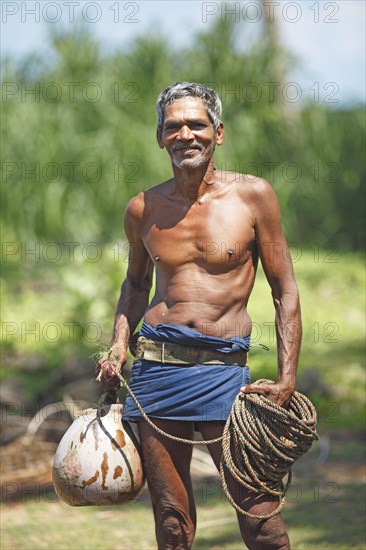 Toddy Tapper with rope for collecting palm juice