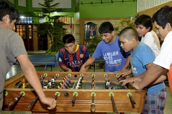 Teenagers playing foosball table