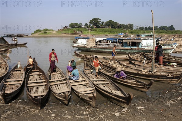 Many wooden boats at the dock in the river Irrawaddy