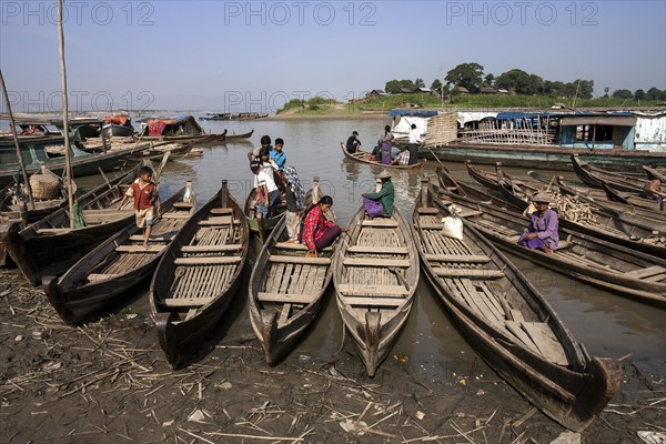 Many wooden boats at the dock in the river Irrawaddy