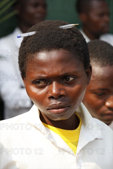 Student with pen in hair