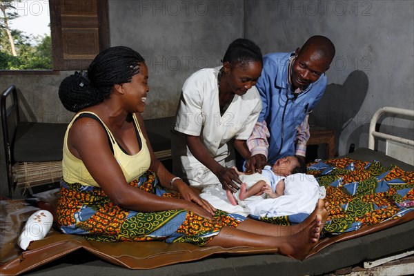 Newborn child being examined by a doctor