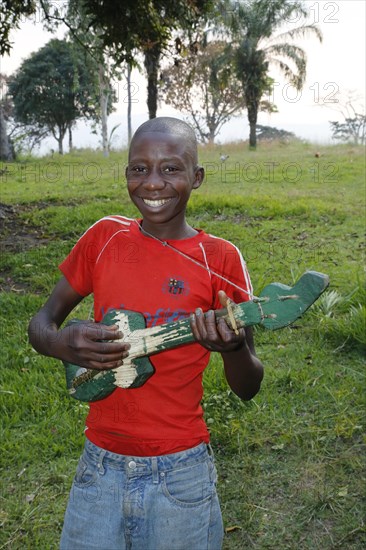 Boy playing on a home-built guitar