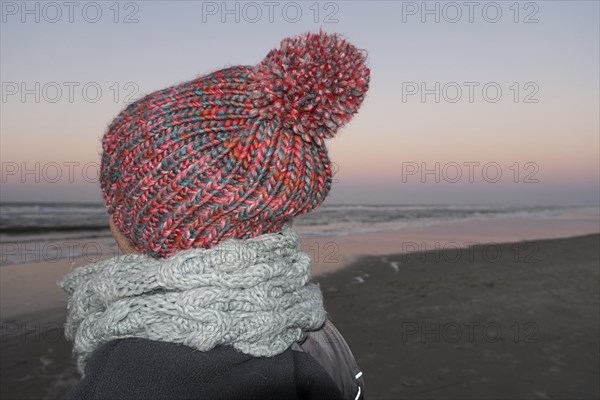 Woman with woolly hat on the beach of the North Sea island of Langeoog