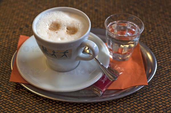 Cappuccino with a glass of water