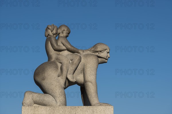 Children riding on woman's back