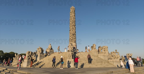 Visitors between granite sculptures